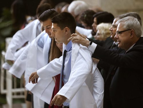 WAYNE GLOWACKI / WINNIPEG FREE PRESS     Pascal Bogaert is formally cloaked by Dr. Terry Babick, right, at the inaugural exercises ceremony for the 110 new medical students from the Max Rady College of Medicine Class of 2020.  The students also recited the Hippocratic Oath at the ceremony with Gary Doer, former Ambassador to the US and and Premier as the key note speaker at the event Wednesday. Nick Martin story  August 24 2016