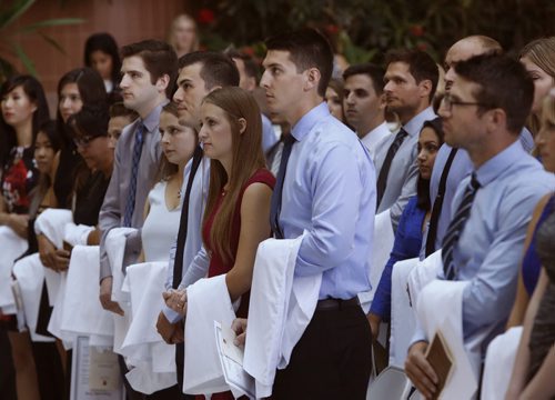 WAYNE GLOWACKI / WINNIPEG FREE PRESS      The 110 new medical students from the Max Rady College of Medicine Class of 2020 listen to the Canadian Anthem at the ceremony were they were formally cloaked in their first white coats and recited the Hippocratic Oath in Brodie Centre, University of Manitoba, Bannatyne Campus.  Gary Doer, former Ambassador to the US and and Premier was the key note speaker at the event Wednesday. Nick Martin story  August 24 2016