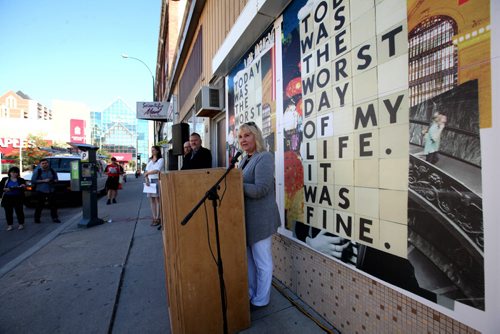 RUTH BONNEVILLE / WINNIPEG FREE PRESS  Ari Driver, Placemaking Committee Chair for Dowtown Biz stands next to  wallpaper creation on Kennedy street announcing new  Downtown Biz initiative called Urban Wallpaper to bring beauty to vacant windows and construction sites at press conference Wednesday.     Aug 24 / 2016
