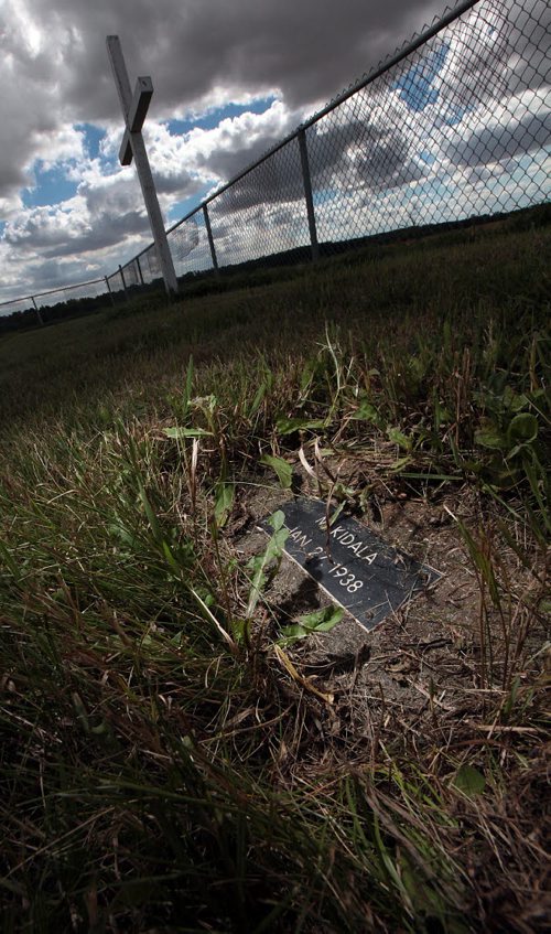 PHIL HOSSACK / WINNIPEG FREE PRESS -  A grave rests in pririe grasses at the Headingley Goal graveyard. See Bill Redekop's story.  August 24, 2016