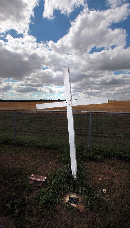 PHIL HOSSACK / WINNIPEG FREE PRESS -  A cruxifix marks the small graveyard from Headingley Goal in the middle of a nearby wheat field. See Bill Redekop's story.  August 24, 2016