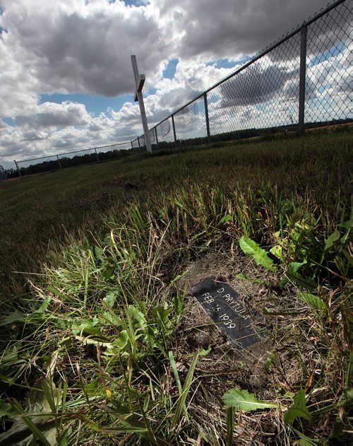 PHIL HOSSACK / WINNIPEG FREE PRESS -  A grave marker rests in prairie grasses at the Headingley Goal graveyard. See Bill Redekop's story.  August 24, 2016