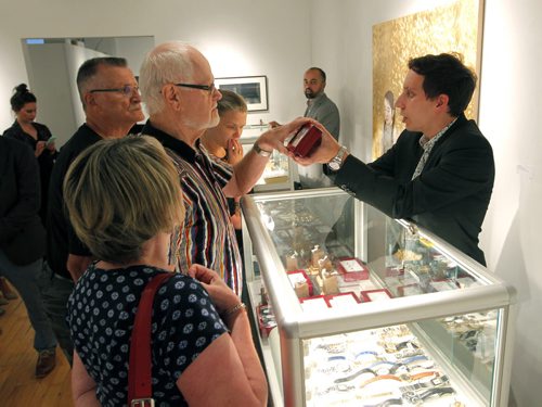 BORIS MINKEVICH / WINNIPEG FREE PRESS COLOURED DIAMONDS FEATURE - Ritchies Auctioneers Fine Jewellery Specialist Jonty Friedman, right, shows some coloured diamonds to people who attended the auction/sale. Various coloured stones and various rings that were on display at the Gurevich Gallery (200-62 Albert Street in Winnipeg). For Jen Zoratti story. August 25, 2016