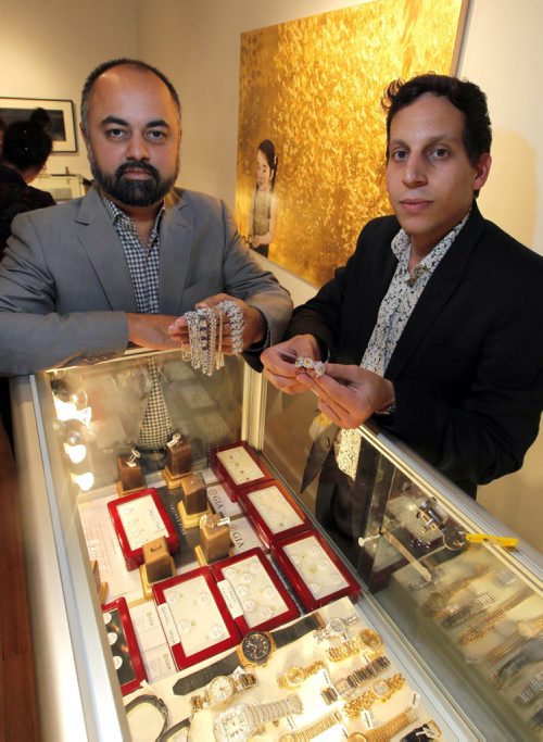 BORIS MINKEVICH / WINNIPEG FREE PRESS COLOURED DIAMONDS FEATURE - Ritchies Auctioneers Director Kashif Kahn, left, and Ritchies Auctioneers Fine Jewellery Specialist Jonty Friedman, right, pose for a photo with some product they brought to Winnipeg for sale/auction. Various coloured stones and various rings that were on display at the Gurevich Gallery (200-62 Albert Street in Winnipeg). For Jen Zoratti story. August 25, 2016