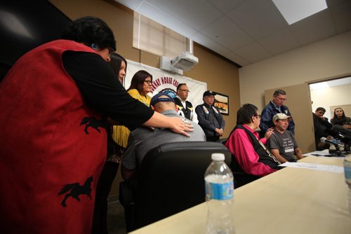 RUTH BONNEVILLE / WINNIPEG FREE PRESS  Family members and friends of Norway House comfort resident Leon Swanson (left) as he turns from the cameras and tears up while former Aboriginal Affairs Minister Eric Robinson comforts Norway House resident David Tait (far right) at press conference announcing  the second case of two children switched at birth(Swanson and Tait)  had been discovered  at Norway House Offices in Winnipeg Friday.    Aug 26, 2016