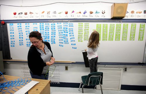 RUTH BONNEVILLE / WINNIPEG FREE PRESS  Local - Isacc Brock photo page for 49.8 Feature / Borders Page for back to school.  Special Education Resource Teacher Erica Barto helps her daughter, Abigail - 6yrs, place high frequency woods on a white board as she prepares for another year of students in her class before  the 2016/2017 school year begins.    August 25, 2016