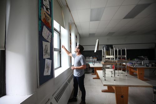 RUTH BONNEVILLE / WINNIPEG FREE PRESS  Local - Isacc Brock photo page for 49.8 Feature / Borders Page for back to school.  Art, technology and Social Studies teacher Jonathan Dueck opens up the window blind as he prepares for his students before the 2016/2017 school year begins.  This is Dueck's first year at Isacc Brock School.     August 25, 2016
