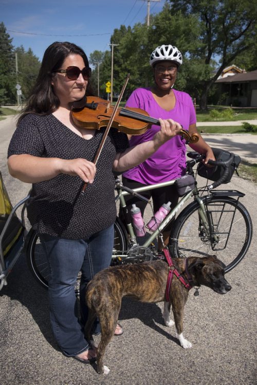 ZACHARY PRONG / WINNIPEG FREE PRESS  Patti Kusturok, left, a renowned fiddler and instructor, with Jasmine Reese, an LA native who is currently completing a bike trip around the world with her dog Fiji. Reese is a classical violin player and while passing through Winnipeg she met with Kusturok for fiddling lessons. August 26, 2016.