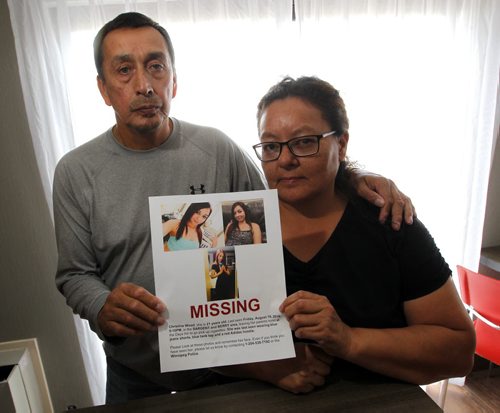 BORIS MINKEVICH / WINNIPEG FREE PRESS George Wood, left, and Melinda Wood, right, (married) pose for a photo at the Comfort Inn Airport @ 1770 Sargent Ave . They hold the poster made for their 21-yr-old daughter Christine, who has been missing since Aug. 19th. Alexandra De Pape story. August 26, 2016
