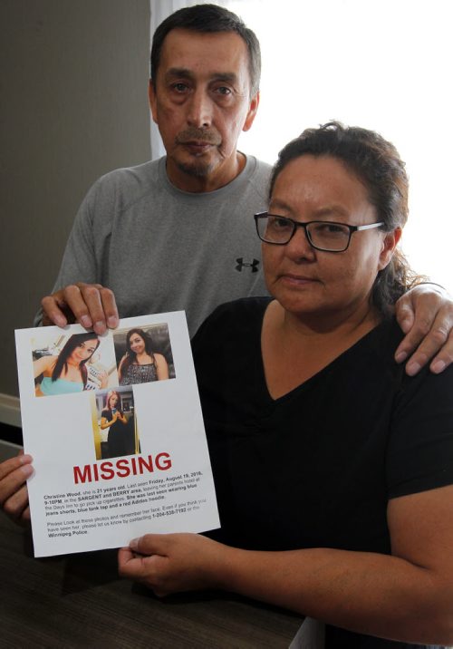 BORIS MINKEVICH / WINNIPEG FREE PRESS George Wood, left/back, and Melinda Wood, right/front, (married) pose for a photo holding the missing person poster for their 21-yr-old daughter Christine, who has been missing since Aug. 19th.  Photo taken at the Comfort Inn Airport @ 1770 Sargent Ave . Alexandra De Pape story. August 26, 2016