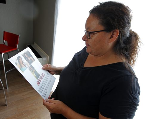 BORIS MINKEVICH / WINNIPEG FREE PRESS Melinda Wood poses for a photo at the Comfort Inn Airport @ 1770 Sargent Ave .  She is looks at the poster made up for her 21-yr-old daughter Christine Wood, who has been missing since Aug. 19th. Alexandra De Pape story. August 26, 2016