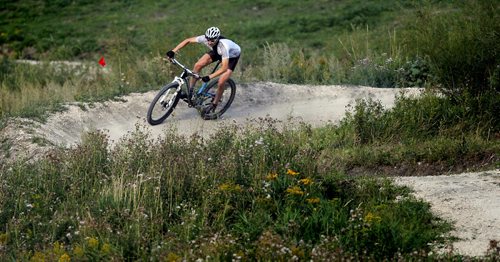 BORIS MINKEVICH / WINNIPEG FREE PRESS Mountain bike athlete Cris LaBossiere of Winnipeg rides the downhill part of Bison Butte Bike Course Friday evening. He is a competitor in tomorrow's (Saturday) Bison Butte Test Event & Provincial Championships in the 50+ class. The site is behind FortWhyte Alive. Spectators can park at FortWhtye Alive and walk down the trail to the site. Admission is free. Around 150 racers of all ages are going to compete tomorrow. Racing starts 8:30 am with the last event start time at 1:45pm. Mountain biking for the Canada Games in 2017 will be held here. August 26, 2016