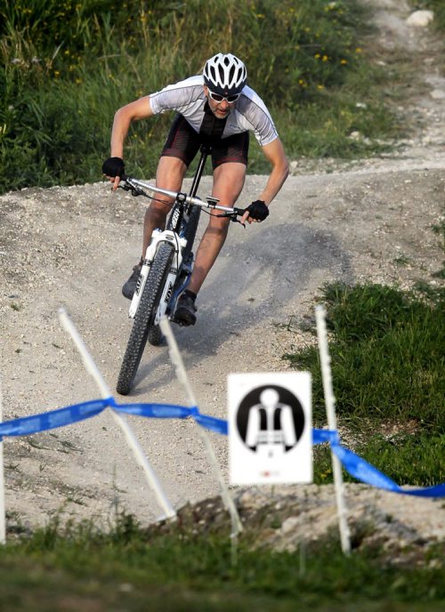 BORIS MINKEVICH / WINNIPEG FREE PRESS Mountain bike athlete Cris LaBossiere of Winnipeg rides the downhill part of Bison Butte Bike Course Friday evening. He is a competitor in tomorrow's (Saturday) Bison Butte Test Event & Provincial Championships in the 50+ class. The site is behind FortWhyte Alive. Spectators can park at FortWhtye Alive and walk down the trail to the site. Admission is free. Around 150 racers of all ages are going to compete tomorrow. Racing starts 8:30 am with the last event start time at 1:45pm. Mountain biking for the Canada Games in 2017 will be held here. August 26, 2016