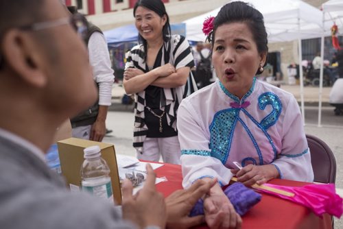 ZACHARY PRONG / WINNIPEG FREE PRESS  Su Mei receives a diagnosis from Zhang Qiu Shi, a traditional Chinese medicine practitioner, at the 8th Annual Chinatown Street Festival on August 27, 2016. Hundreds of Winnipegers were there to enjoy live music, dancing, food and activities for children.