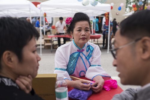 ZACHARY PRONG / WINNIPEG FREE PRESS  Su Mei, centre, receives a diagnosis from traditional Chinese medicine practitioners Zhang Qiu Shi, right, and Jinhua Li at the 8th Annual Chinatown Street Festival on August 27, 2016. Hundreds of Winnipegers were there to enjoy live music, dancing, food and activities for children.