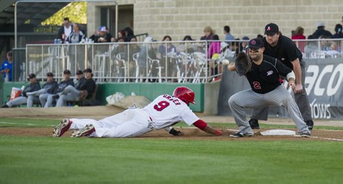 DAVID LIPNOWSKI / WINNIPEG FREE PRESS   Winnipeg Goldeyes Casio Grider (#9) is safe after a pick off attempt while playing against the Sioux City Explorers at Shaw Park Saturday August 27, 2016.