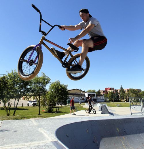 BORIS MINKEVICH / WINNIPEG FREE PRESS STANDUP - Dustin Mailhot catches some major air while pulling off a BMX bike trick called a T-Bog this afternoon at St. Vital Skatepark (within Riel Park). The park is located at 580 St. Anne's Rd (Meadowood Drive and St. Anne's Road) and consists of an 11,000 sq. ft. plaza. It was built in 2003. August 29, 2016