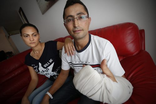 JOHN WOODS / WINNIPEG FREE PRESS Inside their Winnipeg apartment Monday, August 29, 2016 Tahlia Gohari and her husband Shayke, recent newcomers to Winnipeg, show the injuries they received as they were robbed at knifepoint and slashed last Thursday when they took a break outside an entry to Canada transition program.