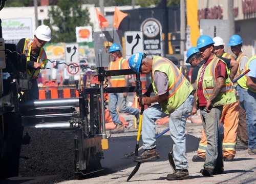JOE BRYKSA / WINNIPEG FREE PRESS Construction crews lay new asphalt on St Marys road in Winnipeg Tuesday- Aug 30, 2016 -(See Santin Story)