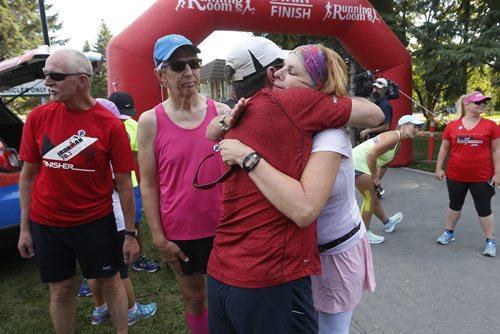 JOHN WOODS / WINNIPEG FREE PRESS Runners and friends comfort each other prior to a memorial 5km run for Joanne Schiewe, who died yesterday of brain cancer, in Winnipeg's Assiniboine Park Tuesday, August 30, 2016