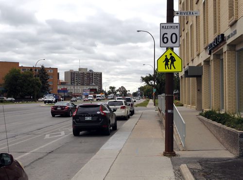 BORIS MINKEVICH / WINNIPEG FREE PRESS School zone speed confusion near the 1600 block of Pembina Highway. There is a sign that posted 60 with a school sign under it. The photo radar guy confirmed he is enforcing 60km/hr and not 50km/hr or 30km/hr. There is some confusion with the two signs being posted together and what the rules are. August 31, 2016