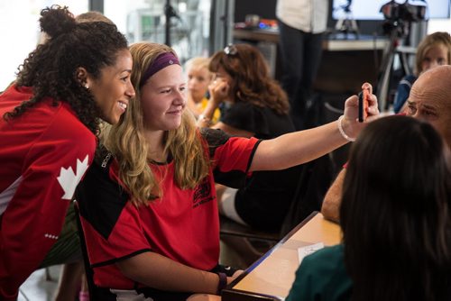 MIKE DEAL / WINNIPEG FREE PRESS Two-time Olympian Champion Desiree Scott appeared at the Winnipeg Free Press News Cafe to sign autographs and talk about her recent experiences during the Rio Olympics with Editor Paul Samyn Wednesday morning. IN PHOTO: Kaitlin Bulawka, 13, takes a selfie with Desiree Scott. 20160831 - Wednesday August 31, 2016
