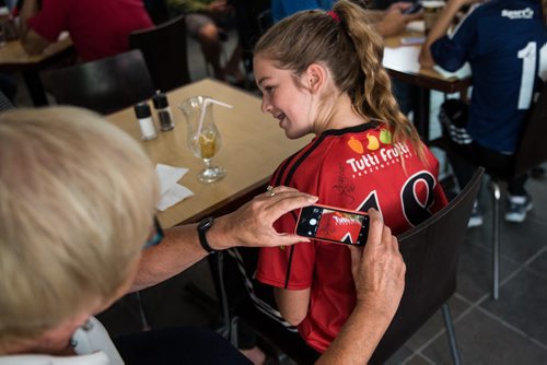 MIKE DEAL / WINNIPEG FREE PRESS Two-time Olympian Champion Desiree Scott appeared at the Winnipeg Free Press News Cafe to sign autographs and talk about her recent experiences during the Rio Olympics with Editor Paul Samyn Wednesday morning. IN PHOTO: Grandmother Roberta Merke takes a photo of Desiree Scott's autograph on, 13-year-old Naomi Epp's jersey. 20160831 - Wednesday August 31, 2016