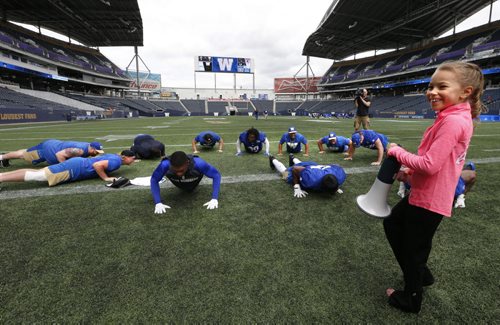 WAYNE GLOWACKI / WINNIPEG FREE PRESS  After the Winnipeg Blue Bombers practice Wednesday at Investors Group Field, some of the players had an opportunity to be put through some additional training by seven year old  Stefanie Gatin, one of Winnipegs top gymnasts in her class. She was selected to experience being a professional football coach  for a day to exemplify Mattel's Barbie dolls' "You Can Be Anything" campaign. The news release states "Barbie, the doll whos experienced 180 careers and counting, believes that young girls can live out any career they can imagine." August 31 2016