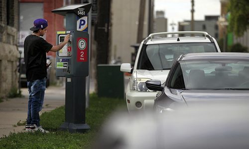 PHIL HOSSACK / WINNIPEG FREE PRESS -  Motorists plug the meter downtown Winnipeg Wednesday. See story.  August 31, 2016