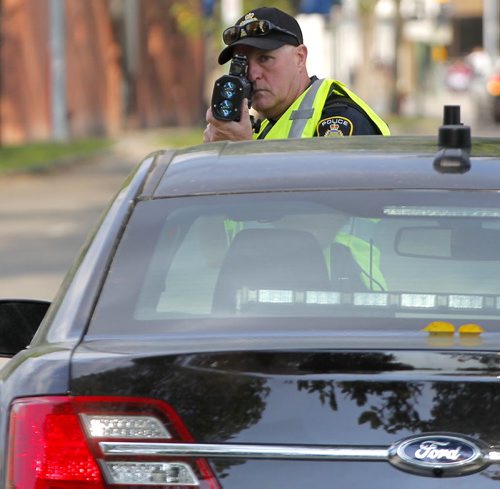 BORIS MINKEVICH / WINNIPEG FREE PRESS SCHOOL ZONE SPEED ENFORCEMENT - Const. Ray Howes enforces the 30km/hr school zone on Bannatyne Ave. near Lydia Street. The fastest car in the zone was 61km/hr  when the photog was there, and it was a teacher that was driving. Here he uses the speed laser gun.  Sept. 1, 2016