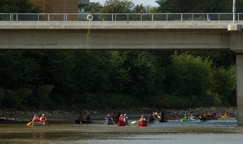 MIKE DEAL / WINNIPEG FREE PRESS Members of the Manitoba chapter of the Canadian Parks & Wilderness Society paddle underneath the Osborne Street Bridge on the Assiniboine River celebrating their 25th anniversary of nature conservation in this province. They started at Omand Park and followed the Assiniboine River to The Forks Thursday morning. 20160901 - Thursday September 1, 2016
