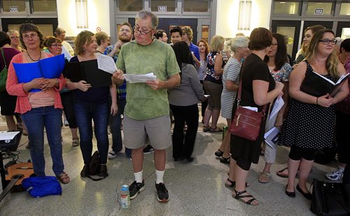 PHIL HOSSACK / WINNIPEG FREE PRESS - Eye of the Storm - Tim Kelly (in green) gathers his score while waiting for the beginning rehearsal and performance at the first concert of the Mass Appeal series of events. This one featured a choir made up on the spot other performances will feature horns, ukelele and more. This evening was held under the dome at Union Station. See Jenn Zoratti's story.   September 1, 2016