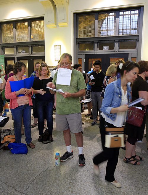 PHIL HOSSACK / WINNIPEG FREE PRESS - Eye of the Storm - Tim Kelly (in green) gathers his score while waiting for the beginning rehearsal and performance at the first concert of the Mass Appeal series of events. This one featured a choir made up on the spot other performances will feature horns, ukelele and more. This evening was held under the dome at Union Station. See Jenn Zoratti's story.   September 1, 2016