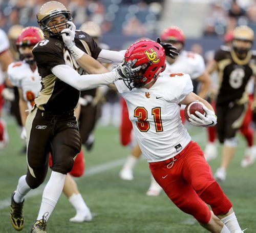 TREVOR HAGAN / WINNIPEG FREE PRESS Manitoba Bisons' Tristen O'Meara tries to tackle Calgary Dinos Quentin Chown during first half CIS football action, Thursday, September 1, 2016.