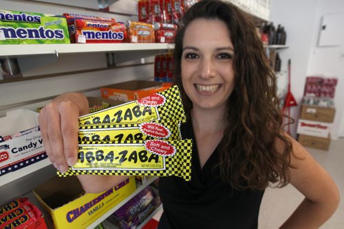 JOE BRYKSA / WINNIPEG FREE PRESSTeeyahs- 166 Hargrave St owner Tia Medeiros in her specialty candy shop holding Abba- Zaba bars- Sept 02, 2016 -(See David Sanderson story)