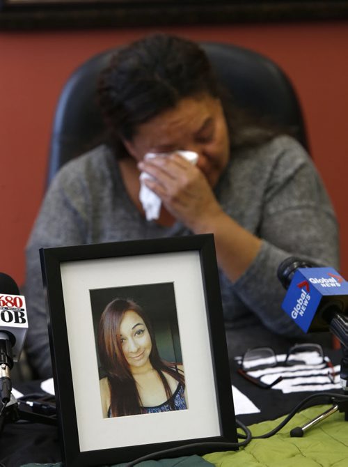 WAYNE GLOWACKI / WINNIPEG FREE PRESS    Melinda Wood, seated behind a photograph of her daughter Christine Wood, made an urgent plea Tuesday to the public for her 21-year-old missing daughter.  The news conference was held at the Manitoba Keewatinowi Okimakanak Inc.  Carol Sanders story Sept. 6  2016