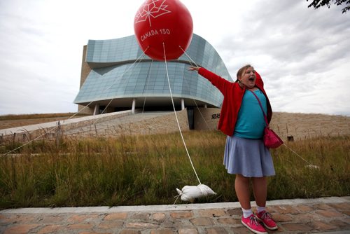RUTH BONNEVILLE / WINNIPEG FREE PRESS

Eleven-year-old Tyra Anderson-Trnka (no i) shows off her excitement outside The Canadian Museum for Human Rights (CMHR) to her parents as they walk by  a huge balloon outside set up for the count down to Canada's 150th birthday year,Tyra and her family were among many visitors to the museum for their special free-admission to the museum Wednesday evening for the upcoming birthday.  

Standup photo 

September 07 2016

