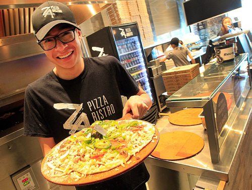 PHIL HOSSACK / WINNIPEG FREE PRESS -   Za - Restraunt review - Alex Chinchilla, the pizza cook mans the oven and slices personal sized pizzas by the dozen at noon. Fast food pizza at 1220 St Mary's road across from St Vital Place, Crowds fill the popular vendor at during and past lunch hiour. See Alison Gilmore's story. September 9, 2016