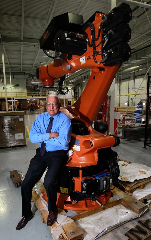 PHIL HOSSACK / WINNIPEG FREE PRESS -  David Johns, President at Winpak poses alongside a robot waiting for final installation of a new $25million state of the art plastic extrusion line at their Salteaux Crescent facility. See Murray McNeil's story. September 15, 2016