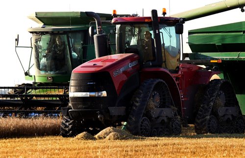 RUTH BONNEVILLE / WINNIPEG FREE PRESS
49.9 Feature harvesting story.
Kaylie Anderson (right, red) drives the wheat cart alongside the combine that her sister Kara is driving. This allows the combine to not waste time stopping to empty the wheat during busy harvest season. Both sisters, as well as their 3 siblings, do whatever it takes to help their familiy during harvest. See Ruth Bonneville's story.
The Anderson family work together to combine one of their fields of wheat that has been in their family for 6 generations on a warm autumn evening Wednesday.
September 14, 2016