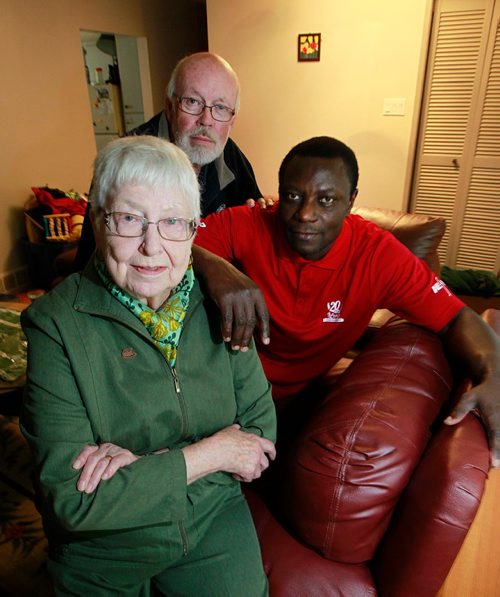 PHIL HOSSACK / WINNIPEG FREE PRESS -  Elisabeth Kunkel (front) Jim Mair and Koffi Sedzro pose at Sedzro's Windsor Park home Friday. He was brought over with aid and sponsorship from the North End Sponsorship Team, (NEST) Jim Mair is the refugee Co-ordinator, Elisbeth a co-founder of the organization.  See Carol Sanders story. September 16, 2016