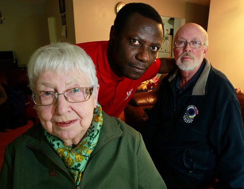 PHIL HOSSACK / WINNIPEG FREE PRESS -  Elisabeth Kunkel (left) Jim Mair (right) and Koffi Sedzro (center) pose at Sedzro's Windsor Park home Friday. He was brought over with aid and sponsorship from the North End Sponsorship Team, (NEST) Jim Mair is the refugee Co-ordinator, Elisbeth a co-founder of the organization.  See Carol Sanders story. September 16, 2016