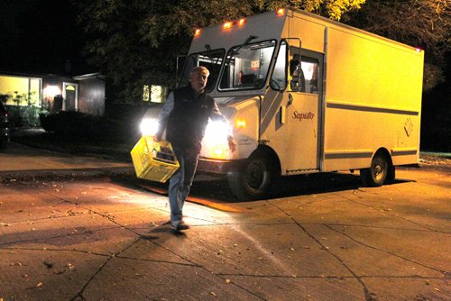 BORIS MINKEVICH / WINNIPEG FREE PRESS
49.8 INTERSECTION - Milkman Garry Peters works his route in the south part of Winnipeg super early Monday Morning. He works for Saputo Inc. (a Montreal-based Canadian dairy company). Here he delivers milk in Fort Garry to a customer in the dark. DAVE SANDERSON STORY. Sept. 19, 2016