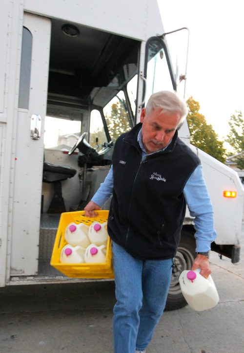 BORIS MINKEVICH / WINNIPEG FREE PRESS
49.8 INTERSECTION - Milkman Garry Peters works his route in the south part of Winnipeg super early Monday Morning. He works for Saputo Inc. (a Montreal-based Canadian dairy company). Morning comes as he keeps on delivering his milk products to customers. This customer in a newer area orders a lot of milk. DAVE SANDERSON STORY. Sept. 19, 2016