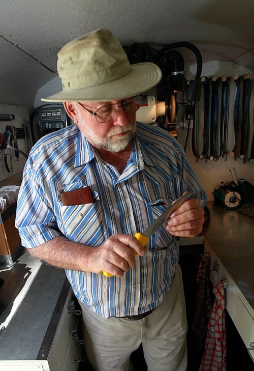 PHIL HOSSACK / WINNIPEG FREE PRESS -  Gord Hymers, tests the edge of a knife's blade in the workshop of his mobile sharpening service. After years of sharpening skateds Gord's retired and moves his tools around town to sharpen knoves and scissors. See Dave Sanderson's story. September 19, 2016