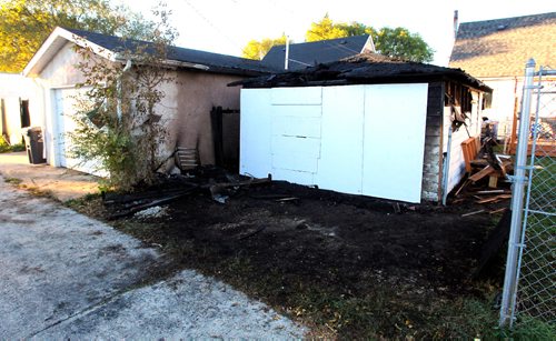 BORIS MINKEVICH / WINNIPEG FREE PRESS
BREAKING NEWS - Shots from an overnight fire in the back lane of 635 Harbison Avenue East. It  burned a garage and spread to the property next to it (#639 Harbison Avenue East). It was boarded up in the morning (white boards). Sept. 20, 2016