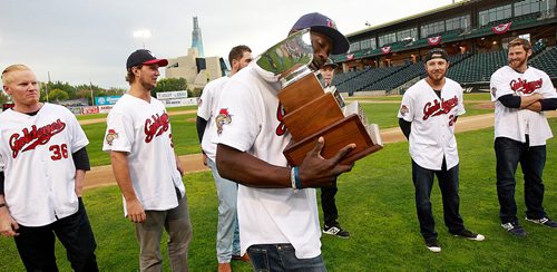 PHIL HOSSACK / WINNIPEG FREE PRESS - CHAMPIONS - Winnipeg Goldeye Reggie Abercrombie reads the engravings on the American Association Championship trophy Wednesday evening at a fan appreciation night in Shaw Park. The Goldeyes captured their third championship in franchise history on Monday with an 11-4 win over the Wichita Wingnuts in Game Five of the American Association Championship Series. See story.   September 21, 2016