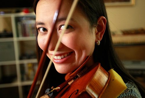 PHIL HOSSACK / WINNIPEG FREE PRESS - Recently-arrived from Montreal, Seven Oaks School Division music teacher and classical violinist Naomi Garrett poses at home  with her instrument. For Sinclair column about her watching international superstar violinist Joshua Bell perform at the opening night of the WSO season Tuesday.   September 21, 2016