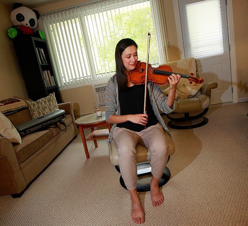 PHIL HOSSACK / WINNIPEG FREE PRESS - Recently-arrived from Montreal, Seven Oaks School Division music teacher and classical violinist Naomi Garrett poses at home  with her instrument. For Sinclair column about her watching international superstar violinist Joshua Bell perform at the opening night of the WSO season Tuesday.   September 21, 2016