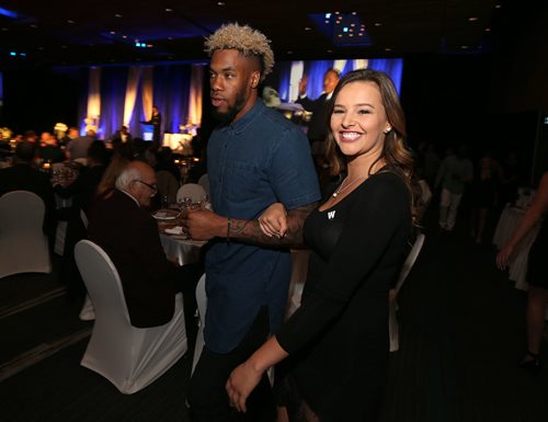 JASON HALSTEAD / WINNIPEG FREE PRESS

Bomber dance team member Katie Wilson shows Bomber wide receiver Thomas Mayo to his seat at the Winnipeg Blue Bombers Legacy Gala Dinner at the RBC Convention Centre Winnipeg on Sept. 21, 2016.